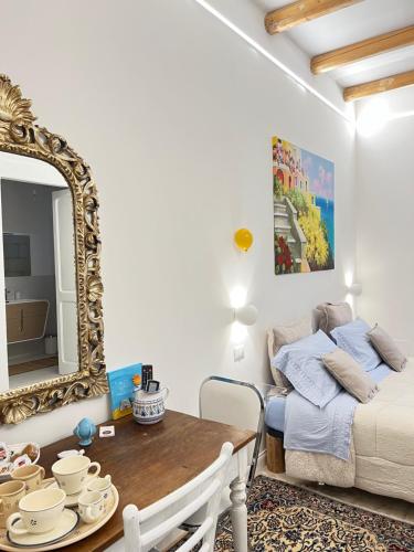 a room with a mirror and a table and a bed at Suite Battisti 7 in Lecce