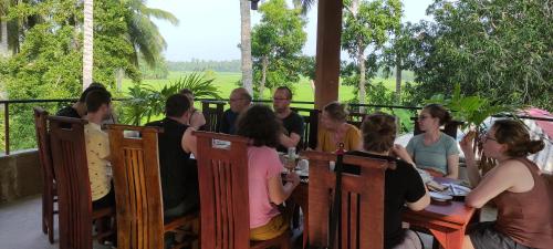 a group of people sitting at a table at Rice Rice Villas in Tissamaharama