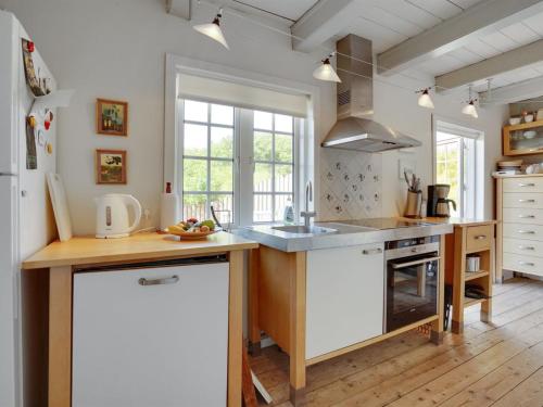 a kitchen with a sink and a counter top at Holiday Home Mattias - 100m from the sea in Western Jutland by Interhome in Fanø