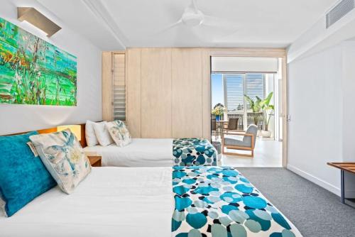 a hotel room with two beds and a couch at 8410 Noosa Sanctuary 2 Bedroom North Facing in Noosa Heads