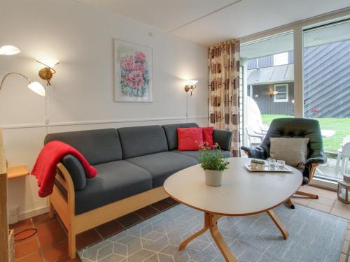 een woonkamer met een bank en een tafel bij Apartment Halina - 100m from the sea in Western Jutland by Interhome in Fanø