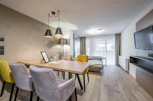 a kitchen and dining room with a table and chairs at Appartements Perberschlager in Oetz