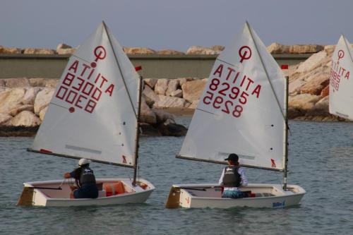 three people in small sailboats on the water at Prati di Maja B&B in Miglianico