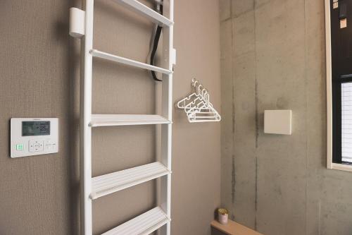a closet with white shelves in a bathroom at Hotel Tabiya ホテルたびや in Tokyo
