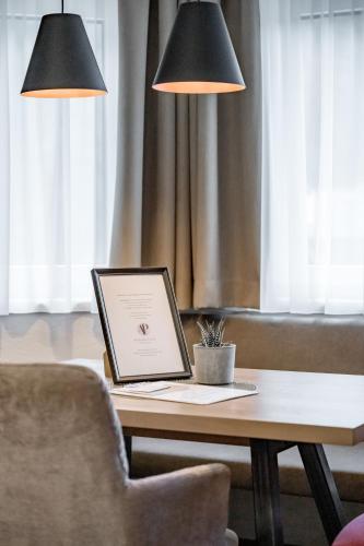a laptop computer sitting on a table with a chair at Appartements Perberschlager in Oetz