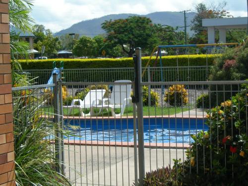 a metal fence around a swimming pool with a pool at Riverside Tourist Park in Rockhampton