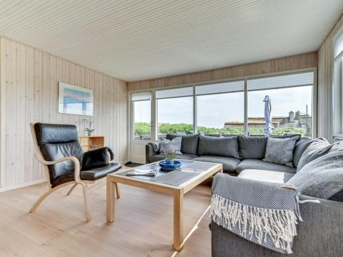 a living room with a couch and chairs and a table at Holiday Home Kris - 200m from the sea in Western Jutland by Interhome in Fanø