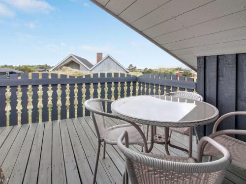 a patio with a table and chairs on a deck at Holiday Home Casandra - 600m from the sea in Western Jutland by Interhome in Fanø