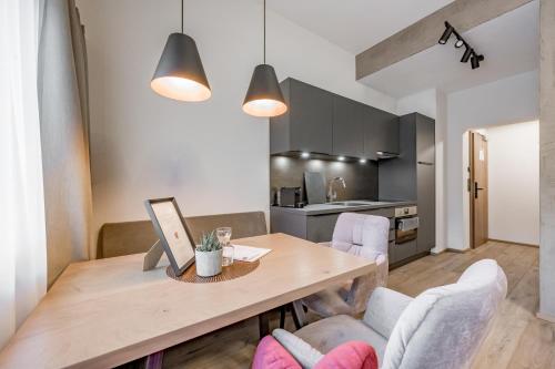 a kitchen and dining room with a wooden table and chairs at Appartements Perberschlager in Oetz