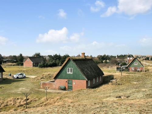 an old house with a grass roof on a hill at Holiday Home Iivari - 1-5km from the sea in Western Jutland by Interhome in Fanø