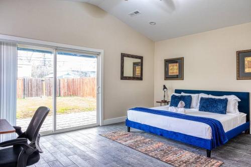 a bedroom with a bed and a sliding glass door at A Craftsman Bungalow - Walk to UC Davis & Shriners in Sacramento