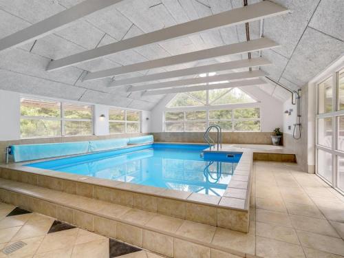 a pool in a house with a swimming pool at Holiday Home Jenna - 1-4km from the sea in Western Jutland in Vesterhede