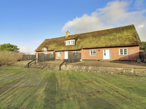 an old brick house with a grass roof at Apartment Labarnas - 800m from the sea in Western Jutland by Interhome in Fanø