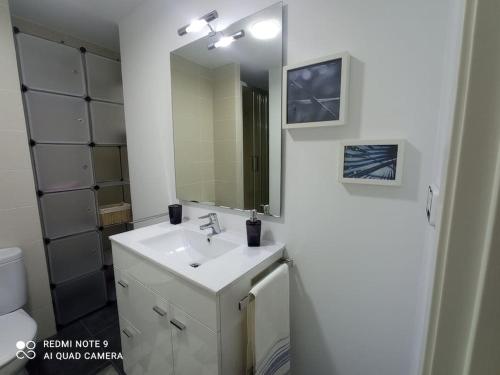 y baño con lavabo y espejo. en Apartamento playa, en La Pobla de Farnals