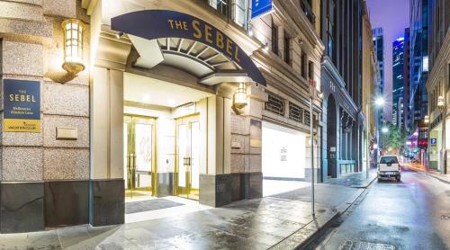 a building with a sign on the side of a street at The Sebel Melbourne Flinders Lane in Melbourne
