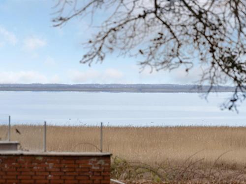 a view of a body of water from a brick wall at Holiday Home Christiern - 4-5km from the sea by Interhome in Kongsmark