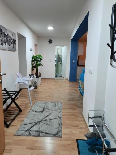 a living room with a table and a rug at Grand Blue 2 Bedroom Apartment Sokobanja in Soko Banja