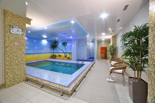 a large swimming pool in a building with a swimming pool at Hotel Avia in Penza