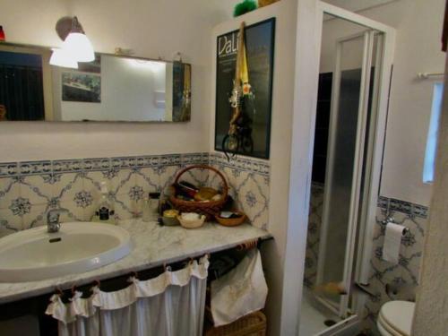 a bathroom with a sink and a shower at Antico Dammuso Al Tramonto in Pantelleria