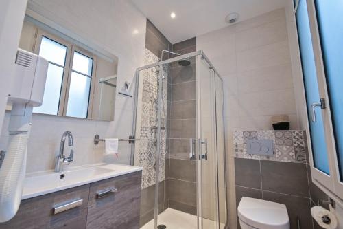 a bathroom with a shower and a toilet and a sink at Les cles du 27 Paris in Paris