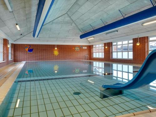 a swimming pool with a slide in the middle of it at Apartment Odger - 2-3km from the sea in Western Jutland by Interhome in Sønderby