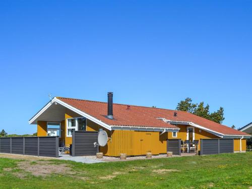 a yellow house with a red roof at Holiday Home Elsbeth - 500m from the sea by Interhome in Lakolk