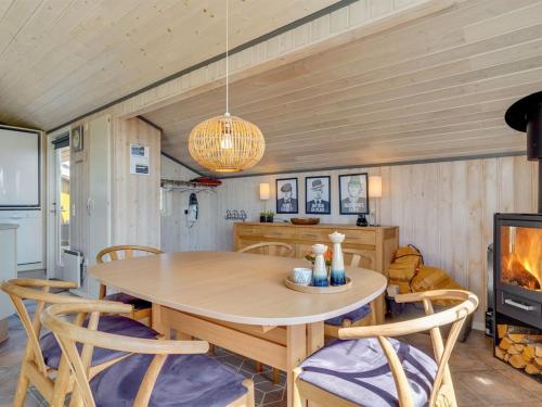 a dining room with a table and chairs and a tv at Holiday Home Elsbeth - 500m from the sea by Interhome in Lakolk