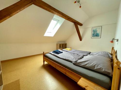a bedroom with a bed in a attic at Sauwohlfühlhof - Ferienhof Winkelkötter in Everswinkel
