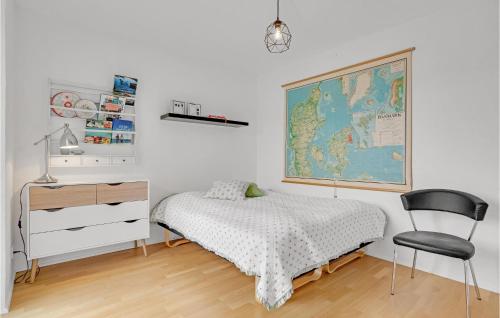 a bedroom with a bed and a map on the wall at Nice Home In Juelsminde With Wifi And 2 Bedrooms in Juelsminde