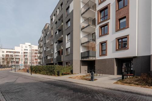 an empty street in front of an apartment building at Chill Apartments Airport Ursynów in Warsaw