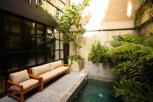 a patio with two chairs and a pool in a building at Hotel Coco in Bogotá