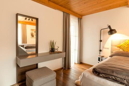 a bedroom with a large mirror and a bed at Ferienhaus Hetzenauer in Kössen