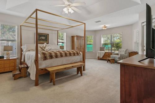 a bedroom with a canopy bed and a living room at Sunset Pass in Middleburg