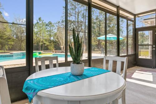 a dining room with a table and chairs and a pool at Sunset Pass in Middleburg