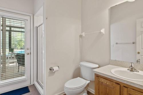 a white bathroom with a toilet and a sink at Sunset Pass in Middleburg