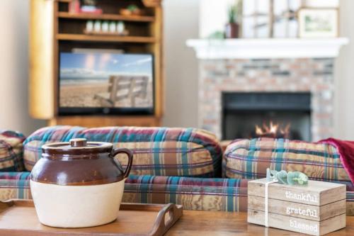 a coffee pot on a table in a living room with a couch at Sunset Pass in Middleburg