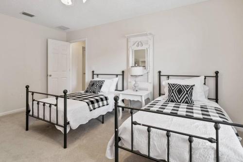 a bedroom with two beds and a mirror at Sunset Pass in Middleburg