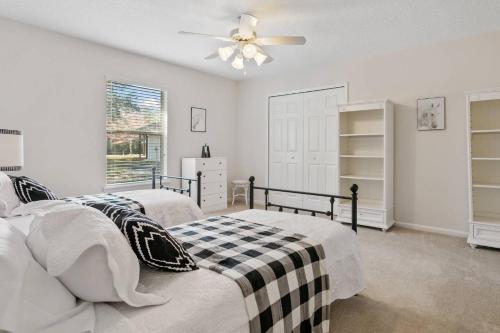 a bedroom with two beds and a ceiling fan at Sunset Pass in Middleburg