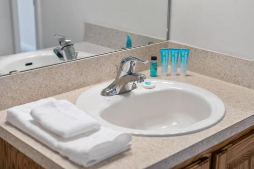 a bathroom counter with a sink with towels on it at Sunset Pass in Middleburg
