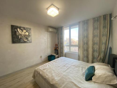 a bedroom with a bed and a window at ANITA B19 LUXORY Apartment Sunny Beach in Sunny Beach