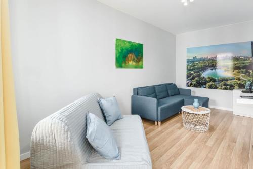 a living room with a couch and a chair at Chill Apartments Airport Ursynów in Warsaw