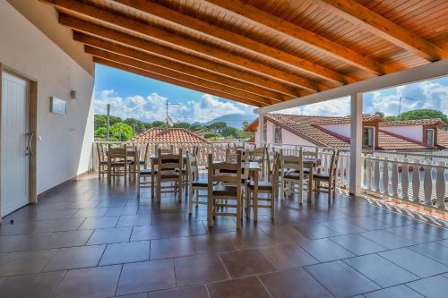 a dining room with a table and chairs on a balcony at Il Pineto Paestum Food & Rooms in Paestum