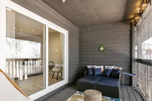 a porch with a blue couch on a patio at The Den at The Ravines in Middleburg
