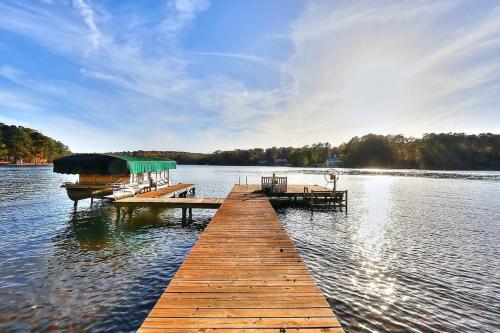 a dock on a lake with two boats on it at Lake Oconee Stunning views, deep water oversized dock, fully renovated in Eatonton