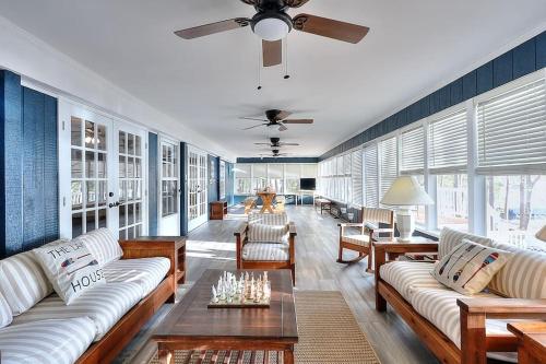 a large living room with couches and a ceiling fan at Lake Oconee Stunning views, deep water oversized dock, fully renovated in Eatonton