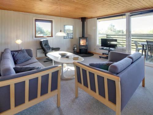 a living room with two couches and a table at Holiday Home Sara - 2-5km from the sea in Western Jutland by Interhome in Bolilmark