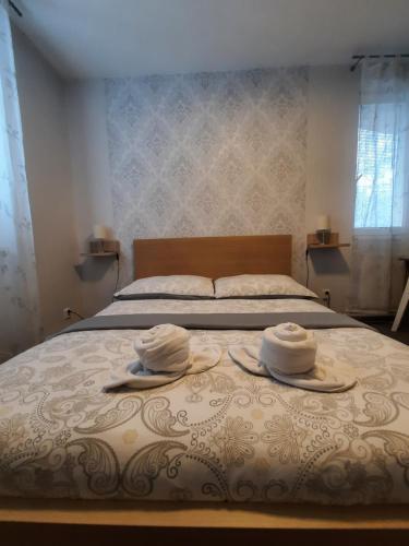a bedroom with a bed with two hats on it at Hotel Boršičanka in Havířov