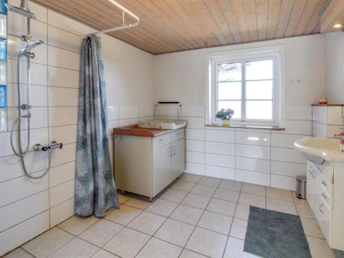 a bathroom with a shower and a sink at Holiday Home Øvli - 3-8km from the sea in Western Jutland by Interhome in Bolilmark