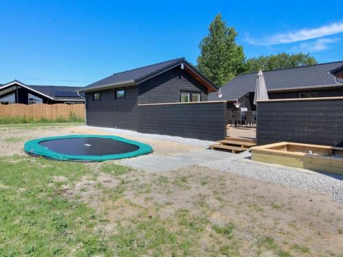 a backyard with a swimming pool and a house at Holiday Home Tahvo - 3-3km from the sea by Interhome in Rømø Kirkeby