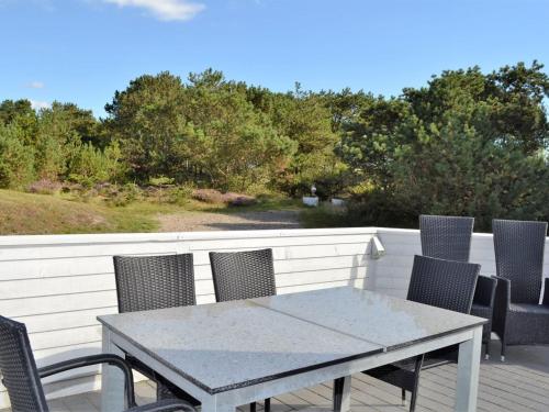 une table et des chaises assises sur une terrasse dans l'établissement Apartment Niilo - 1-7km from the sea in Western Jutland by Interhome, à Sønderby